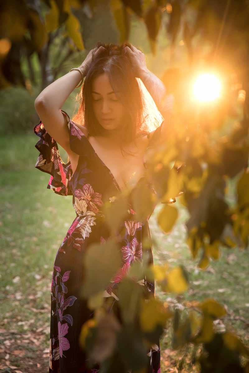 Glamour photoshoot with girl backlit in natural environment